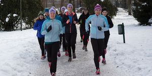 Women running in the snow as part of the 261 Fearless winter training programme